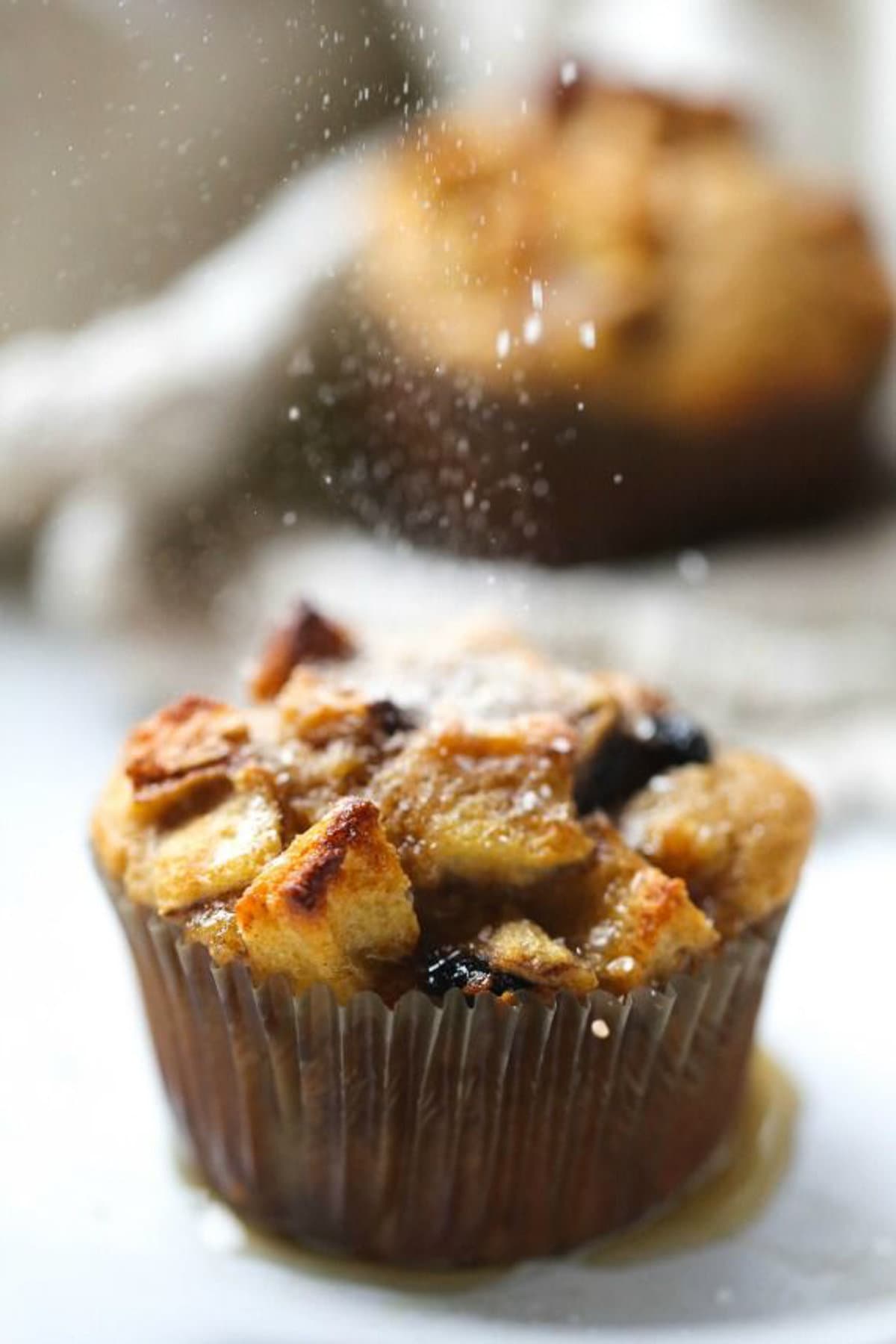 Topping finished french toast muffin with sugar as a garnish