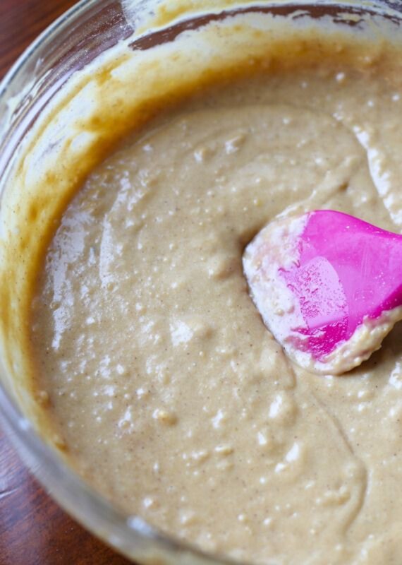 These French toast muffins have custard-soaked French toast pieces baked on top, finished with maple syrup and crunchy cinnamon sugar. Cinnamon muffin batter mixed together in a bowl.