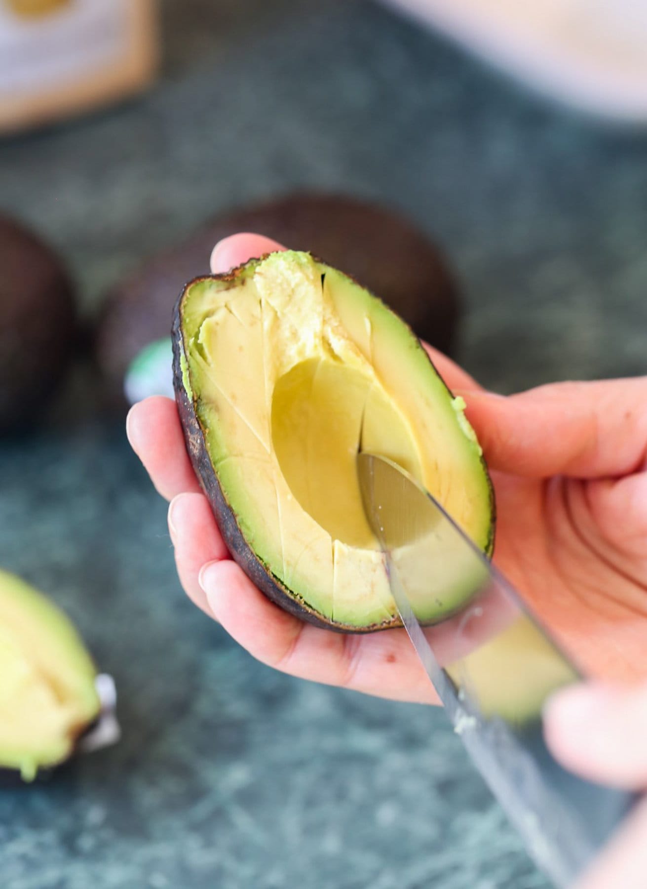 Cutting avocado up into pieces 