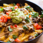 Skillet Frachos topped with cheese and guacamole