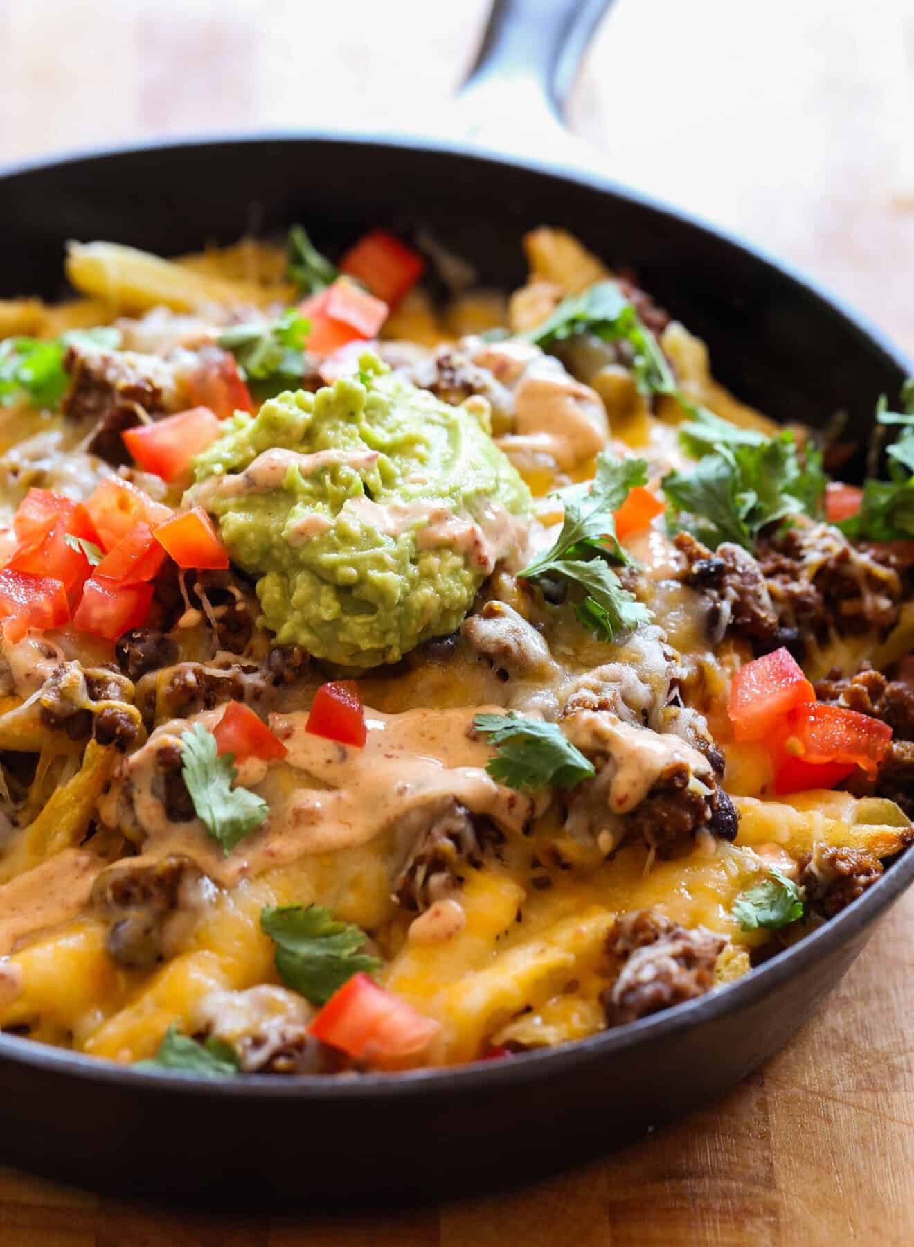 Skillet Frachos topped with cheese and guacamole 