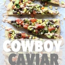 Overhead view of slices of Cowboy Caviar Pizza lined up on parchment paper