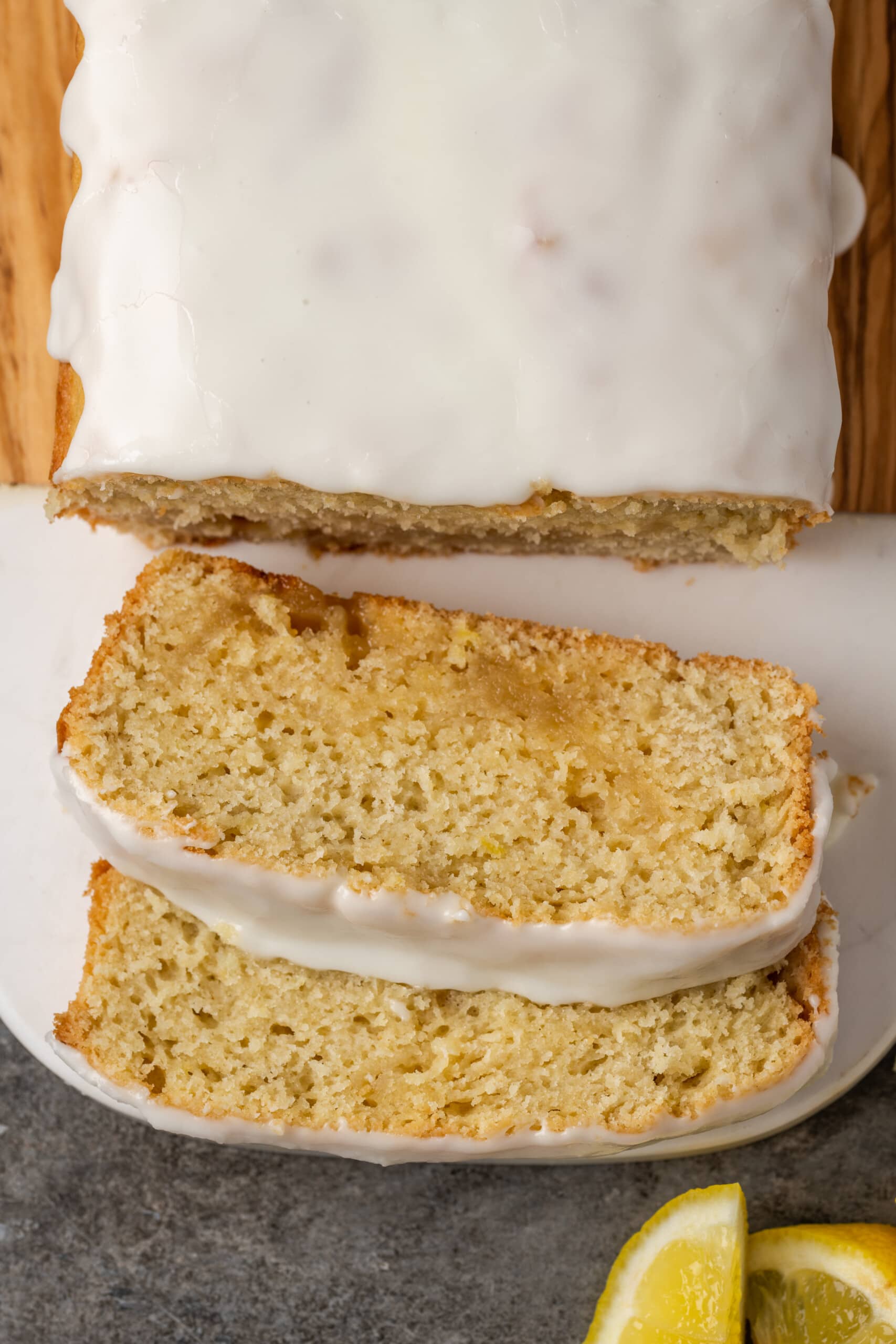 Overhead view of slices cut from a glazed lemon pound cake.