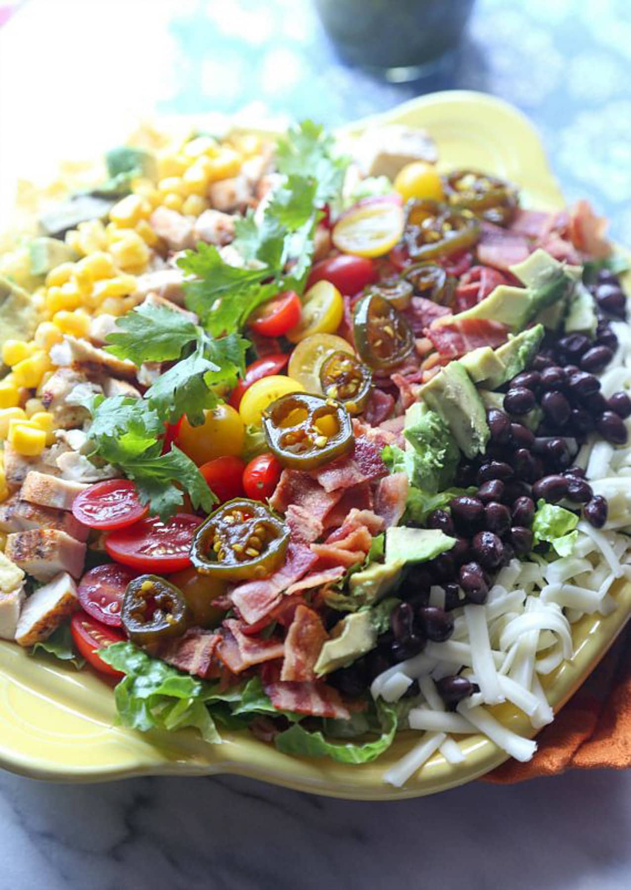 Mexican Cobb salad topped with jalapeños 