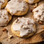 Glazed butter pecan cookies on a wooden platter.