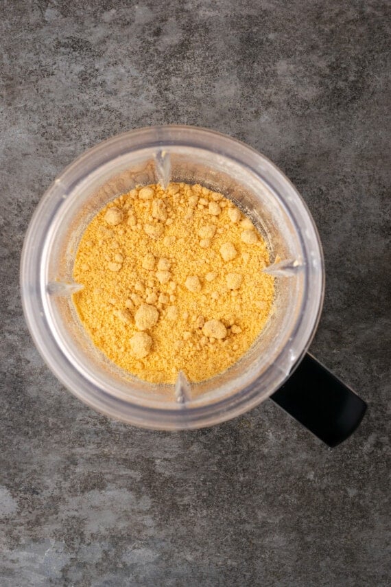 Overhead view of pulverized butterscotch chips inside a blender.