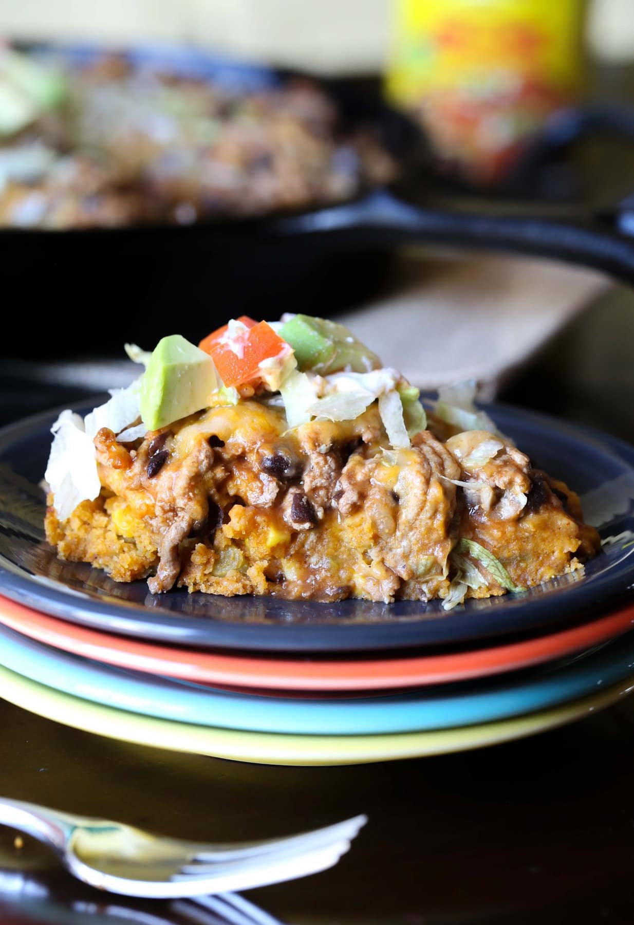 Tamale Pie served on a plate topped with sour cream