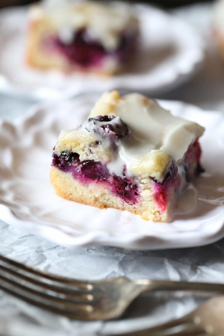 These soft Glazed Berry Sugar Bars are bursting with summer berry flavors! The cookie is soft and buttery, the berries are sweet and flavorful and it's all topped with a creamy sugar glaze!