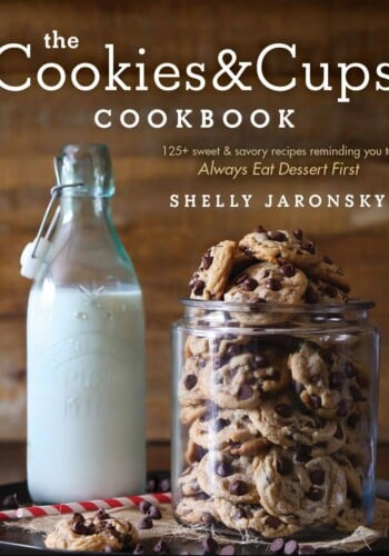 A Jar of Homemade Chocolate Chip Cookies Beside an Old-Fashioned Glass of Milk
