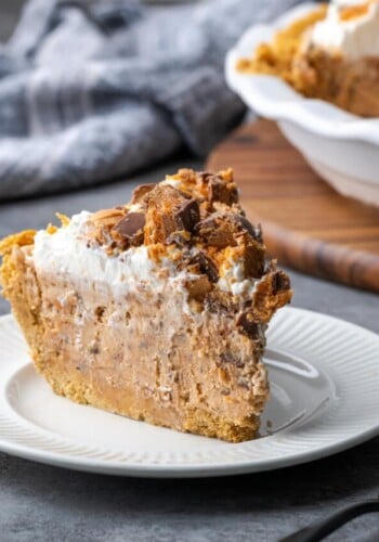 A slice of Butterfinger pie on a white plate.