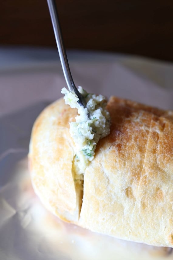 Fork stuffing garlic bread mix in between slices of bread