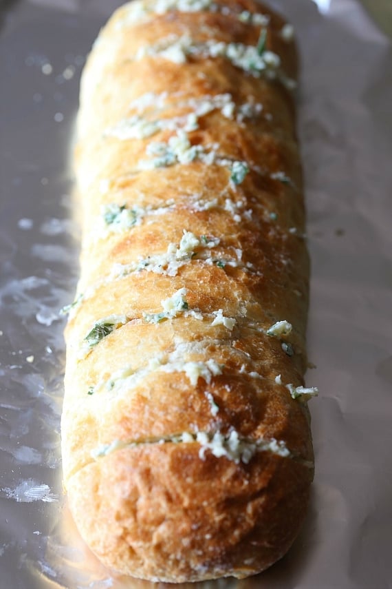 Sliced loaf of french bread stuffed with garlic bread mix.