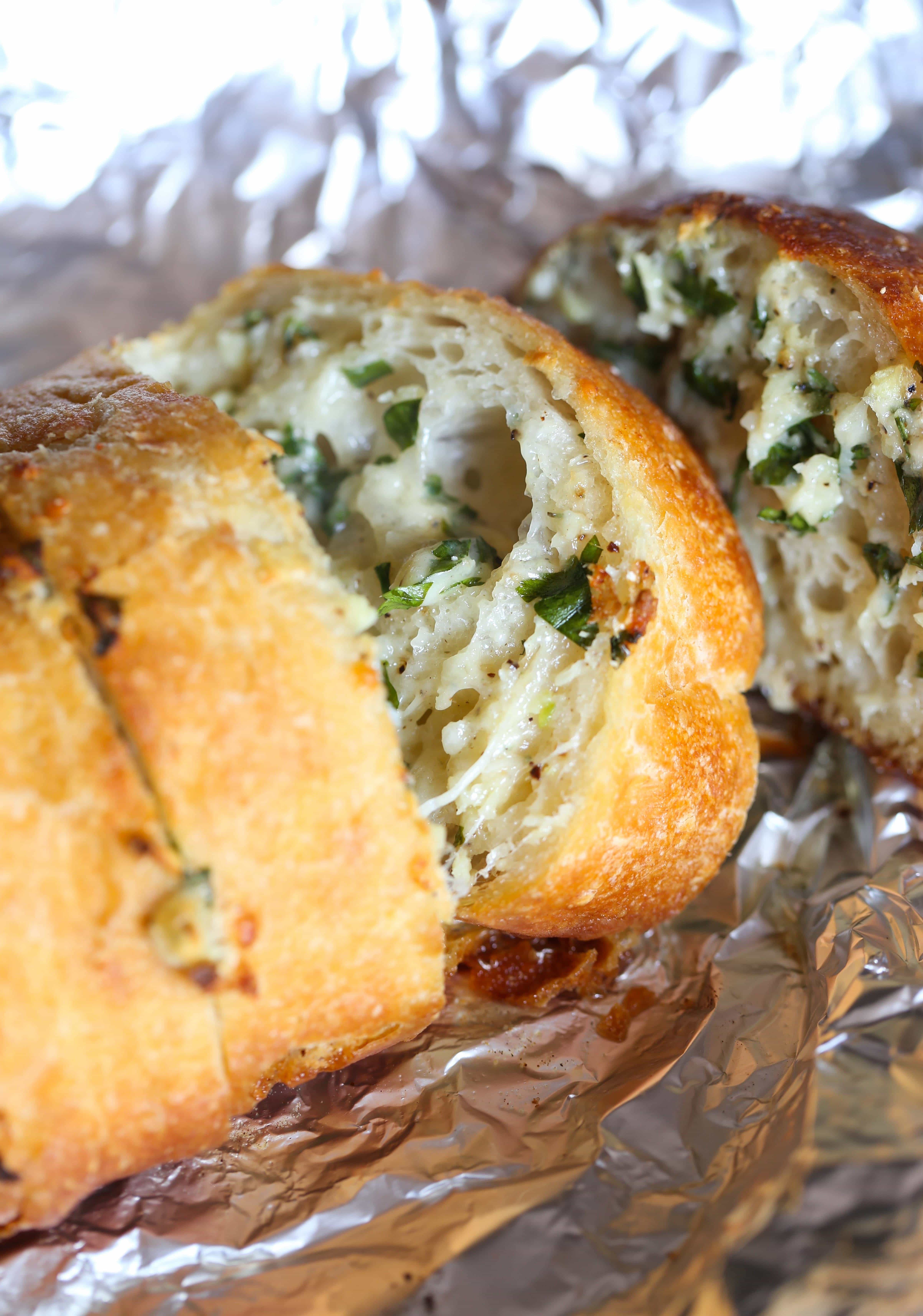 Sliced homemade garlic bread in foil