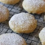 A Kentucky Butter Cake Cookie dusted with powdered sugar on a cooling rack