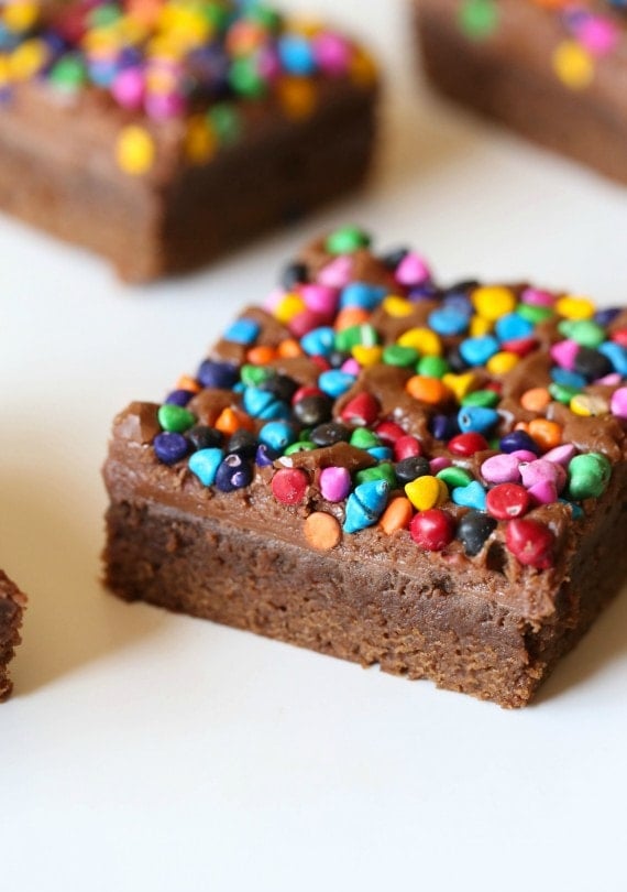 Rainbow Chip Brownies. So easy, sweet and chewy with a chocolaty frosting spread on when the brownies are still warm! All topped with adorable, colorful rainbow chips! You could use M&Ms or sprinkles too!