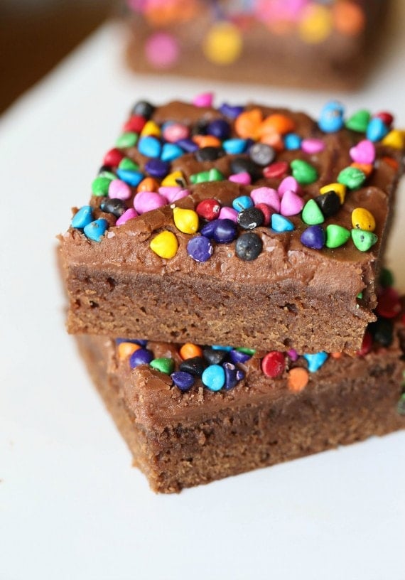 Rainbow Chip Brownies. So easy, sweet and chewy with a chocolaty frosting spread on when the brownies are still warm! All topped with adorable, colorful rainbow chips! You could use M&Ms or sprinkles too!