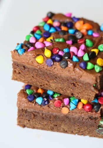 Rainbow Chip Brownies. So easy, sweet and chewy with a chocolaty frosting spread on when the brownies are still warm! All topped with adorable, colorful rainbow chips! You could use M&Ms or sprinkles too!