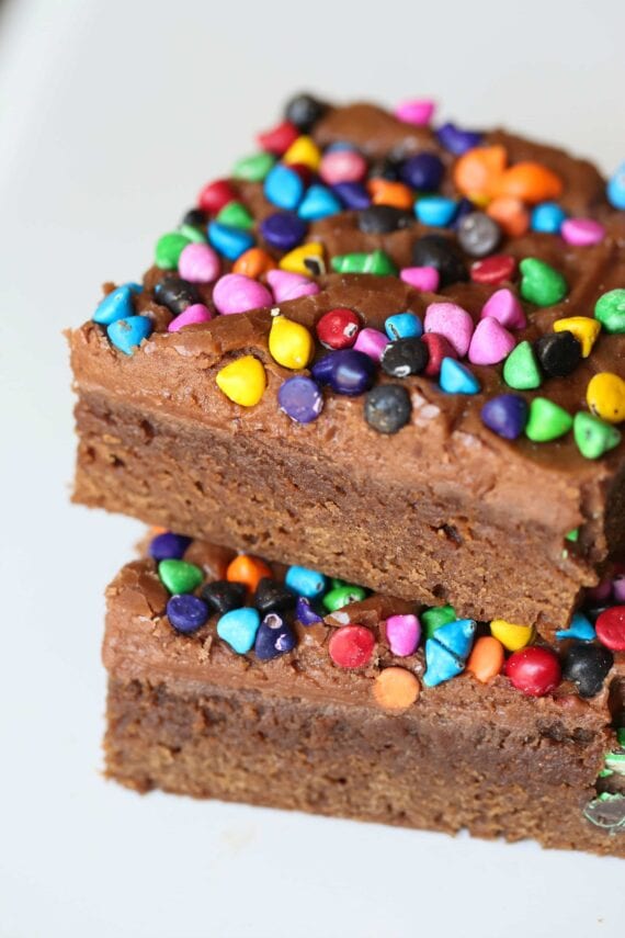 Rainbow Chip Brownies. So easy, sweet and chewy with a chocolaty frosting spread on when the brownies are still warm! All topped with adorable, colorful rainbow chips! You could use M&Ms or sprinkles too!