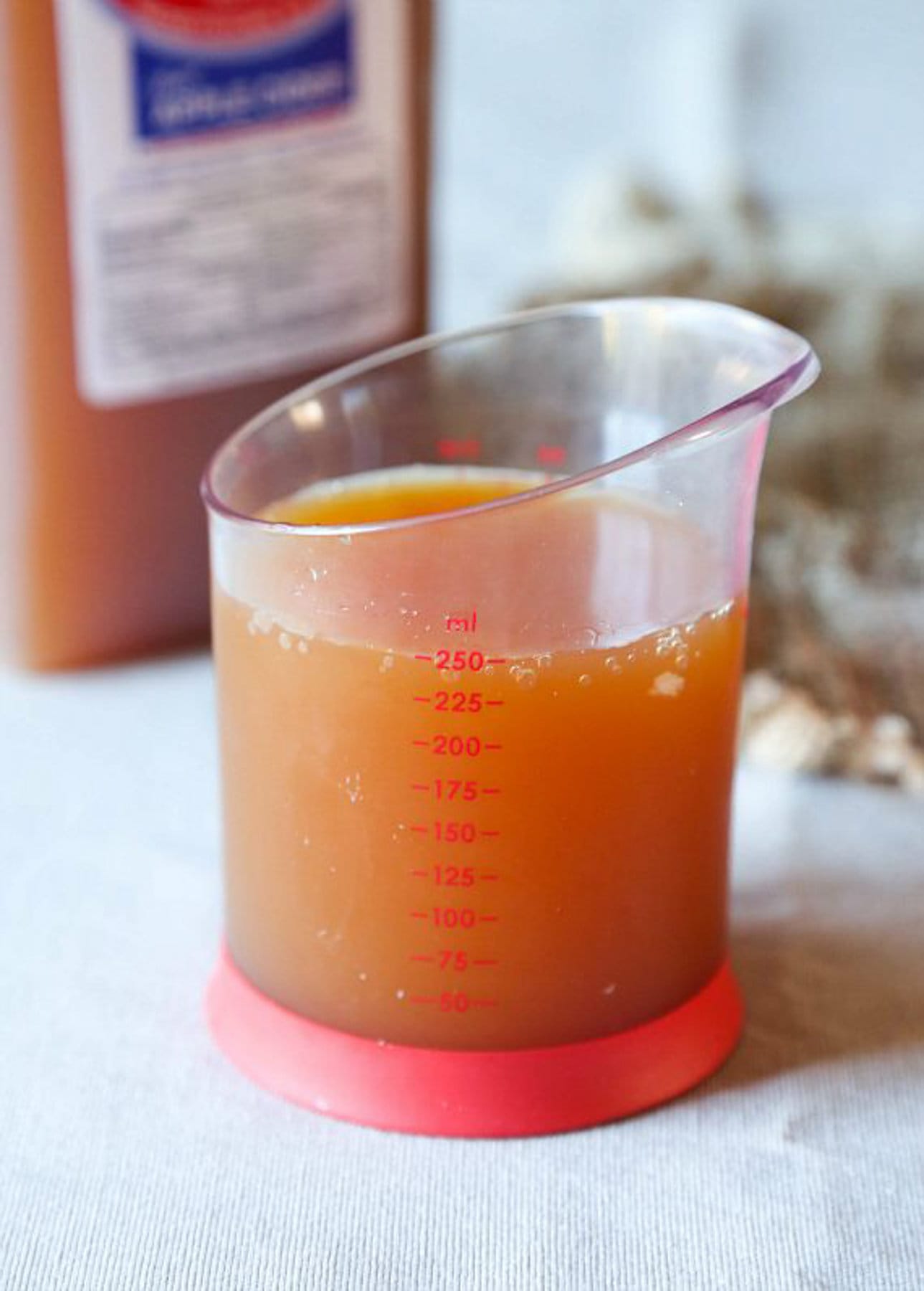250 mL of apple cider in a measuring cup