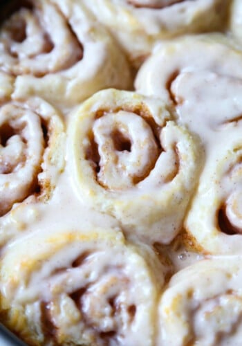 Biscuit cinnamon rolls topped with a white sugar glaze