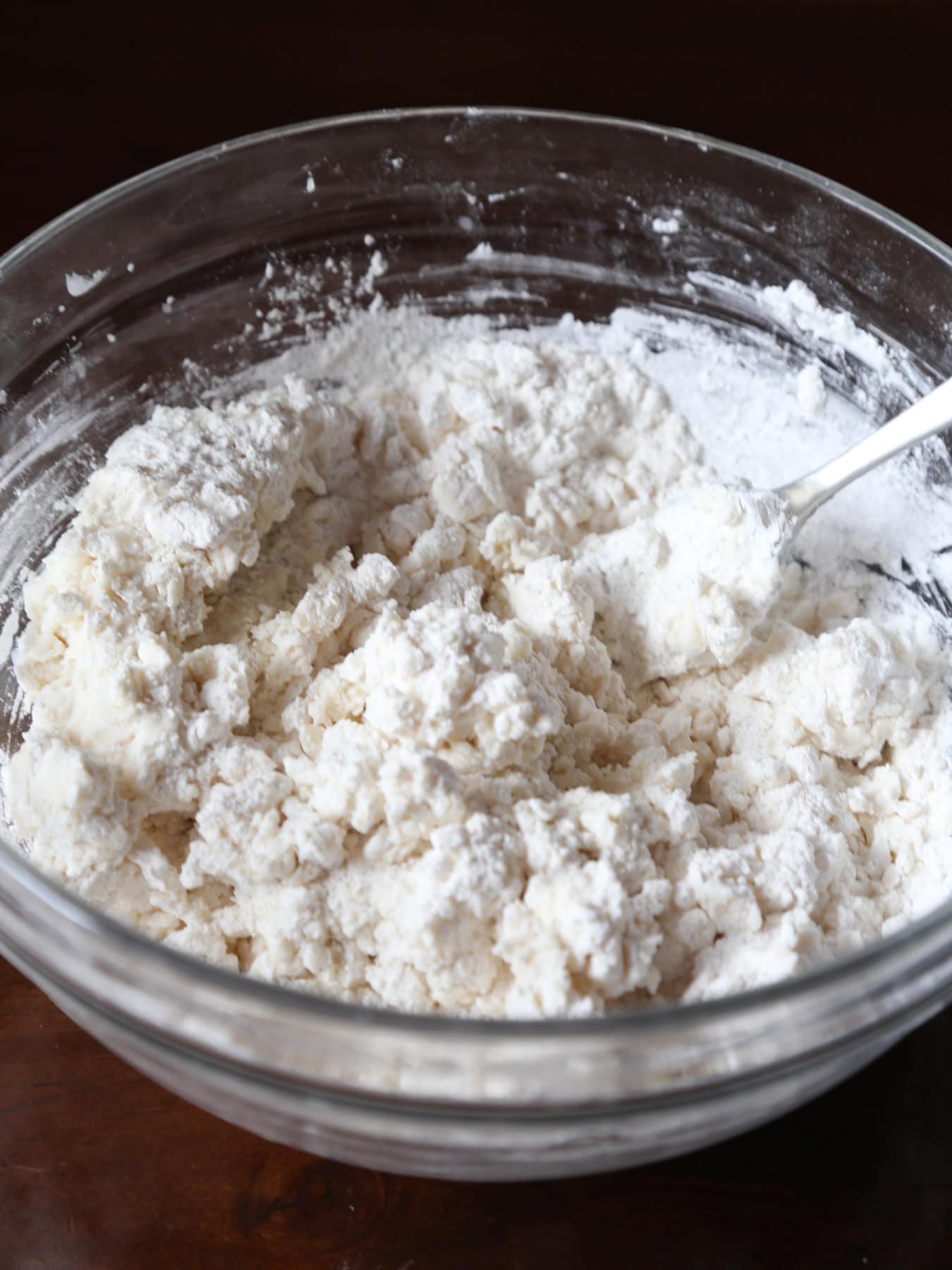Buttermilk, flour, and butter cut together in a clear bowl