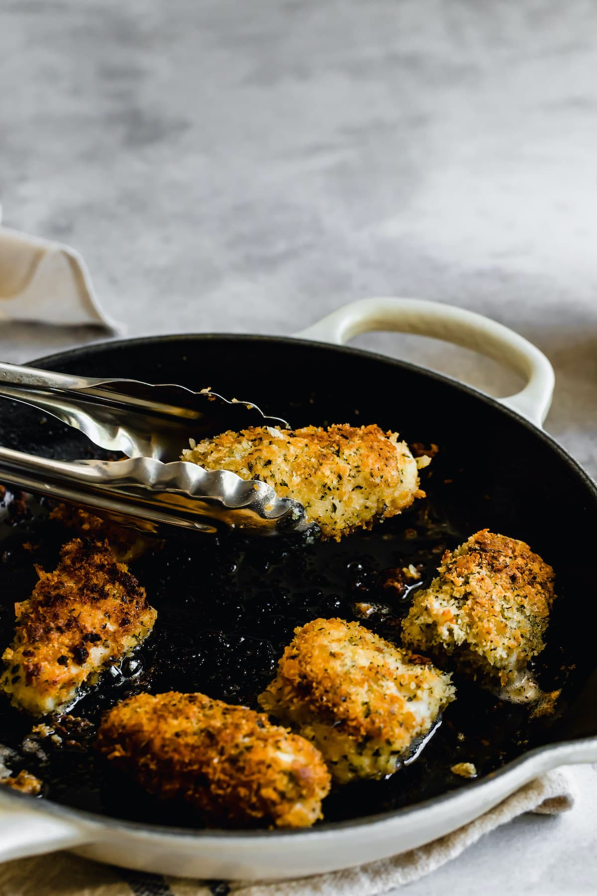 Chicken frying in a skillet.