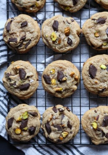 Chocolate chunk pistachio cookies on a wire rack from above