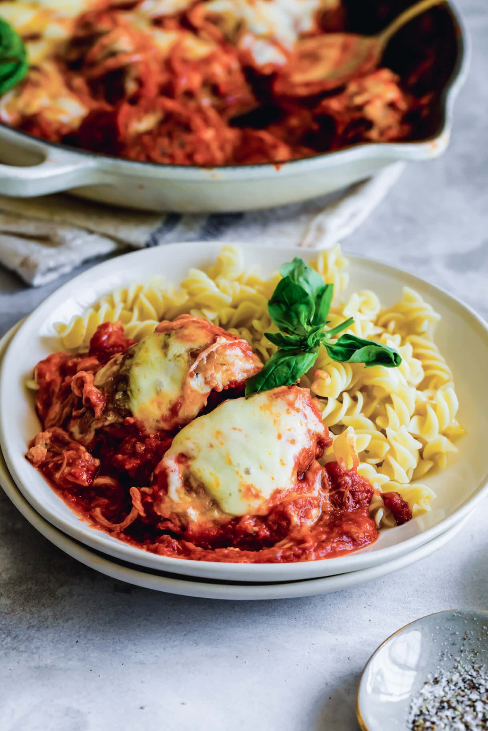 Plate of chicken parmesan with pasta.