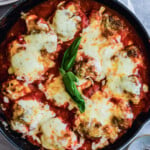 Skillet chicken parmesan with basil.