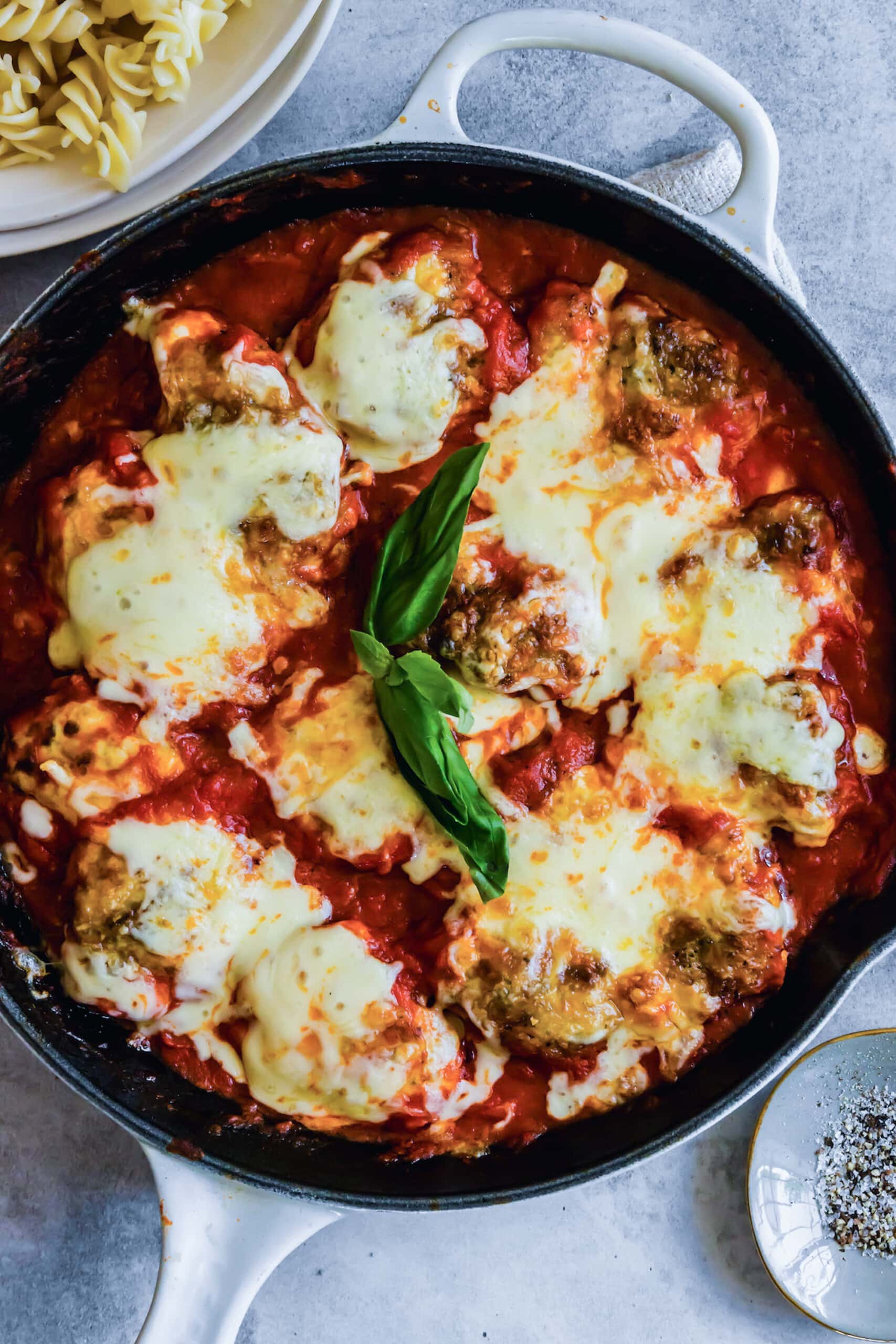Skillet chicken parmesan with basil.