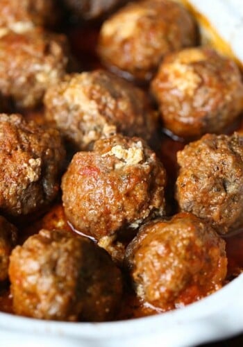 Cooked ricotta stuffed meatballs inside the slow cooker.