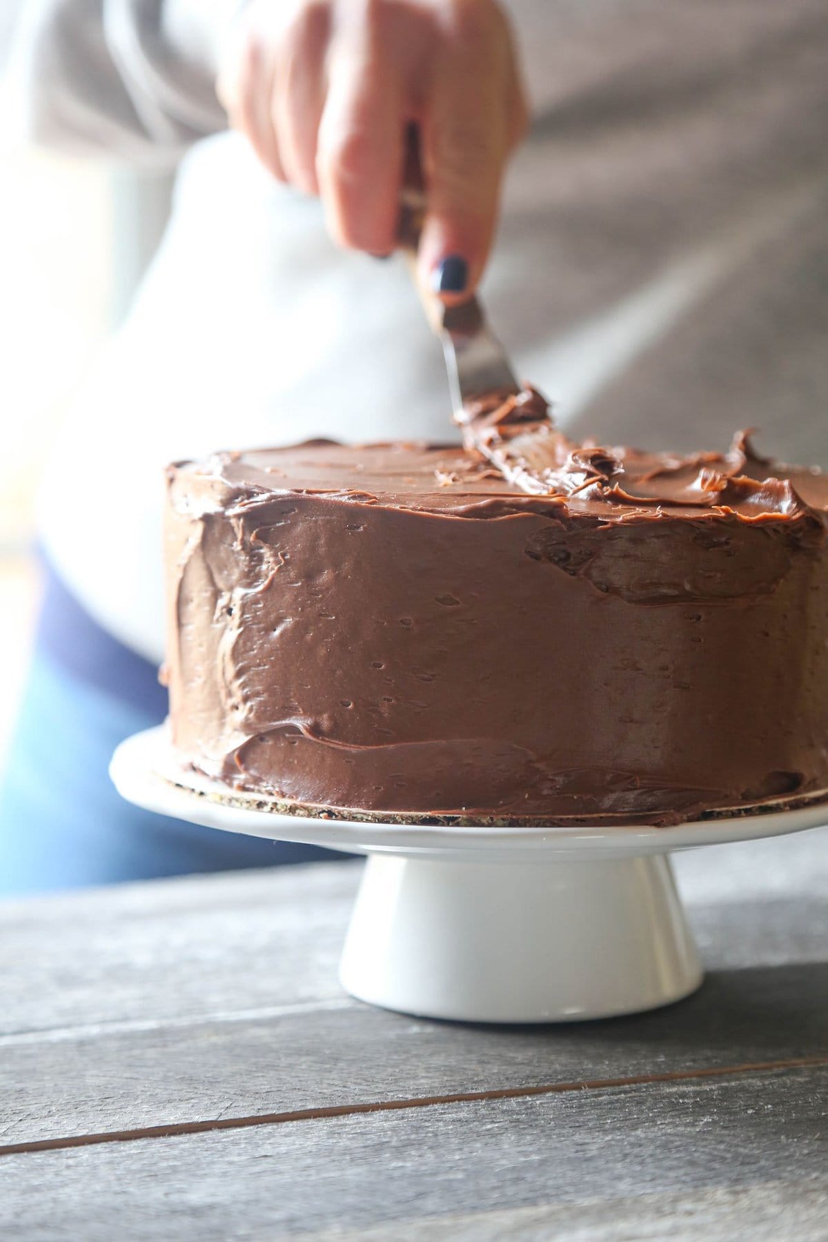 Chocolate frosting spread on cake