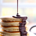 Nutella hot fudge being drizzled over pancakes