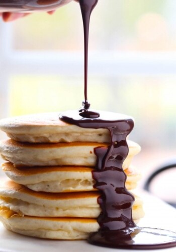 Nutella hot fudge being drizzled over pancakes