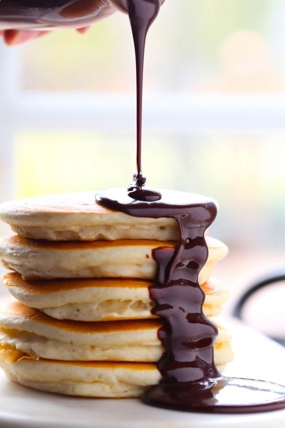 Nutella hot fudge being drizzled over pancakes