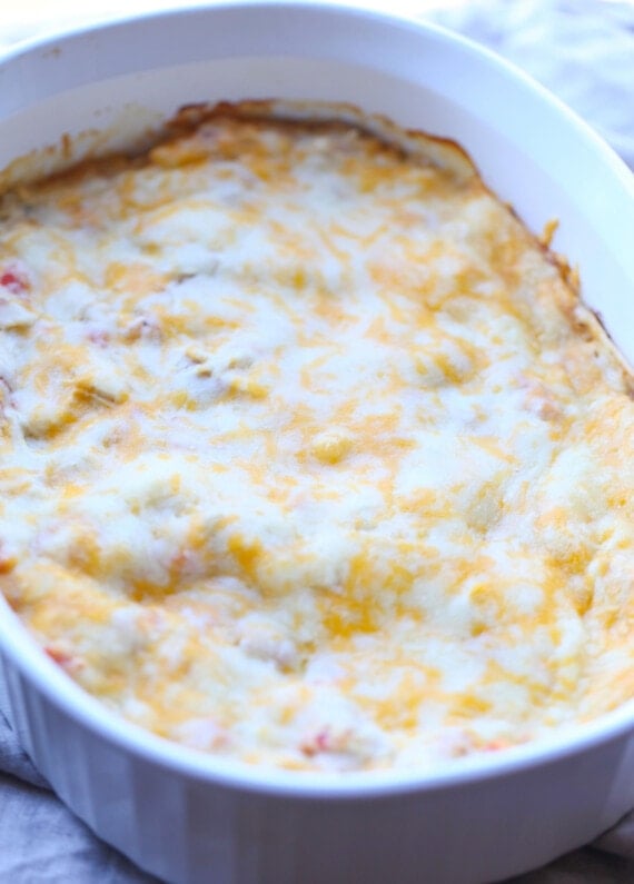 Baked salsa verde chicken casserole covered with melted cheese.