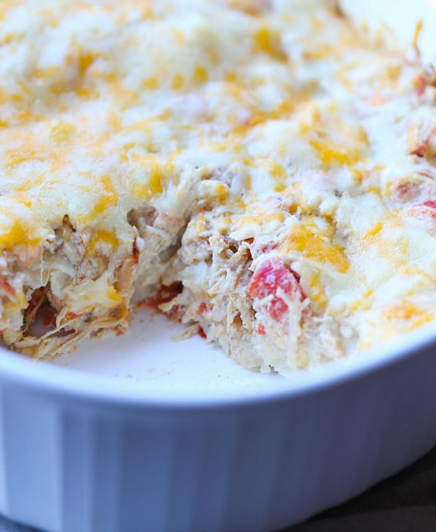 Salsa verde chicken casserole with a slice missing.