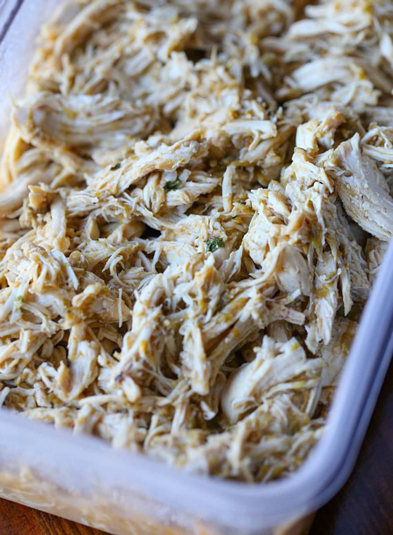 A container of shredded salsa verde chicken.