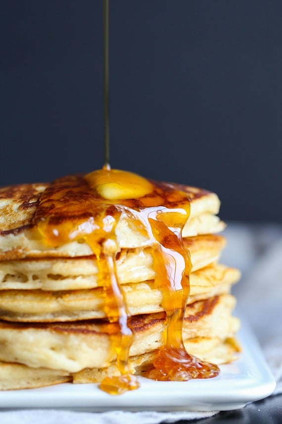 A stack of pancakes with syrup and butter