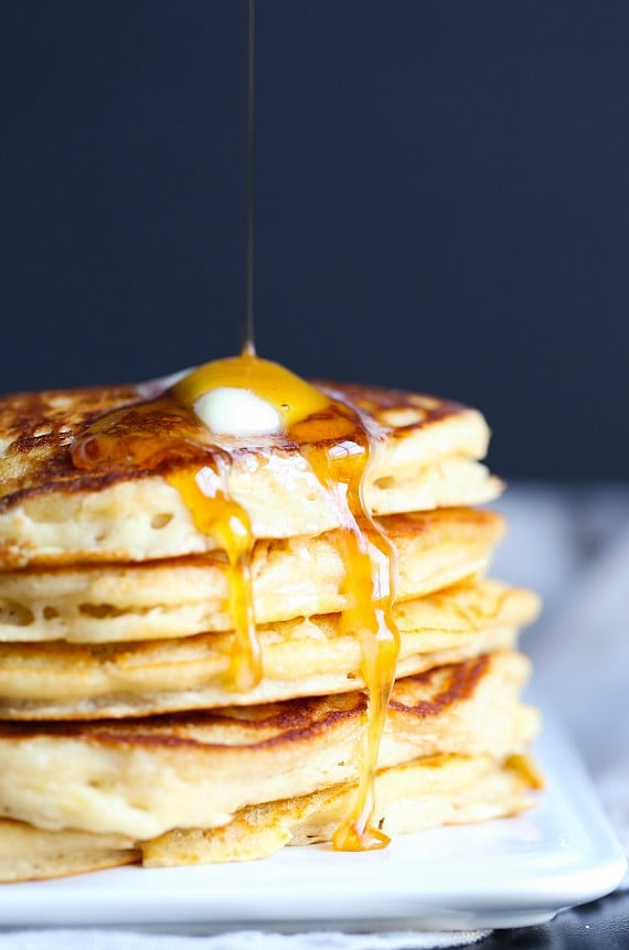 A stack of pancakes with syrup and butter