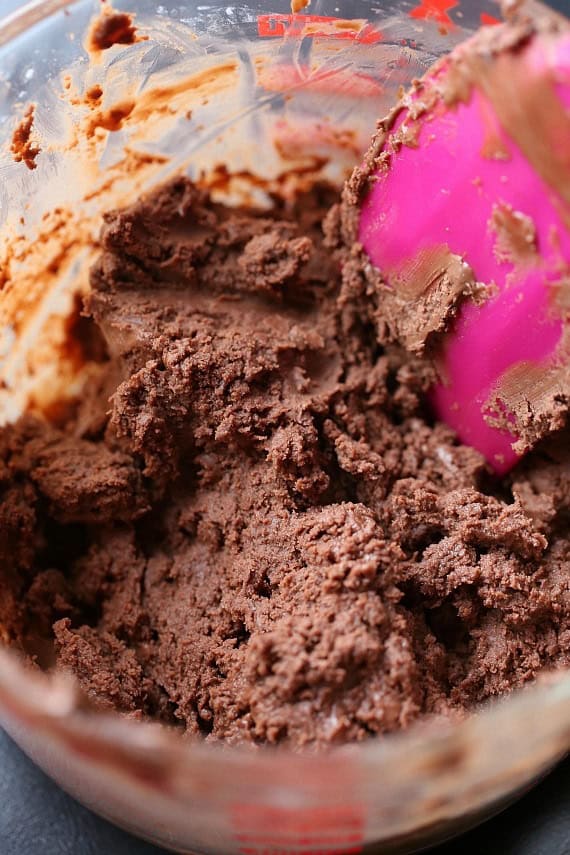 Nutella truffle brownie filling in a mixing bowl with a pink spoon.