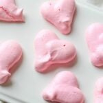 Heart Shaped Meringue Cookies on white parchment paper.