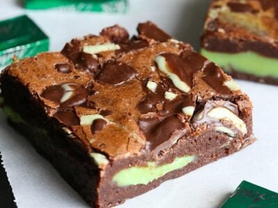 An assortment of mint fudge stuffed brownies surrounded by mint chocolate candies.