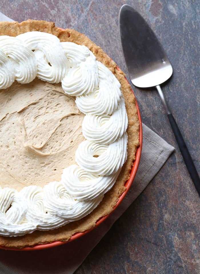 A Cookie Butter Pie with Cream Cheese Crust Beside a Metal Dessert Spatula