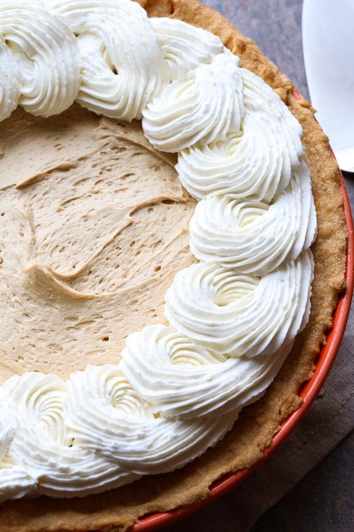 A Cookie Butter Pie Topped with Swirls of Homemade Whipped Cream