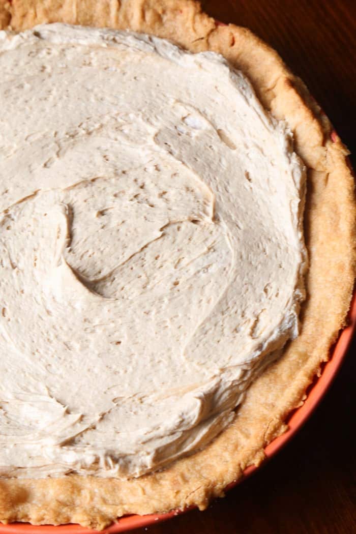 Cookie Butter Pie Filling Spread Onto a Baked Cream Cheese Crust