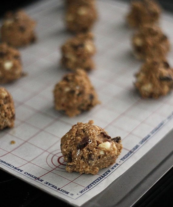 Oatmeal raisin cookie dough balls on a baking sheet.