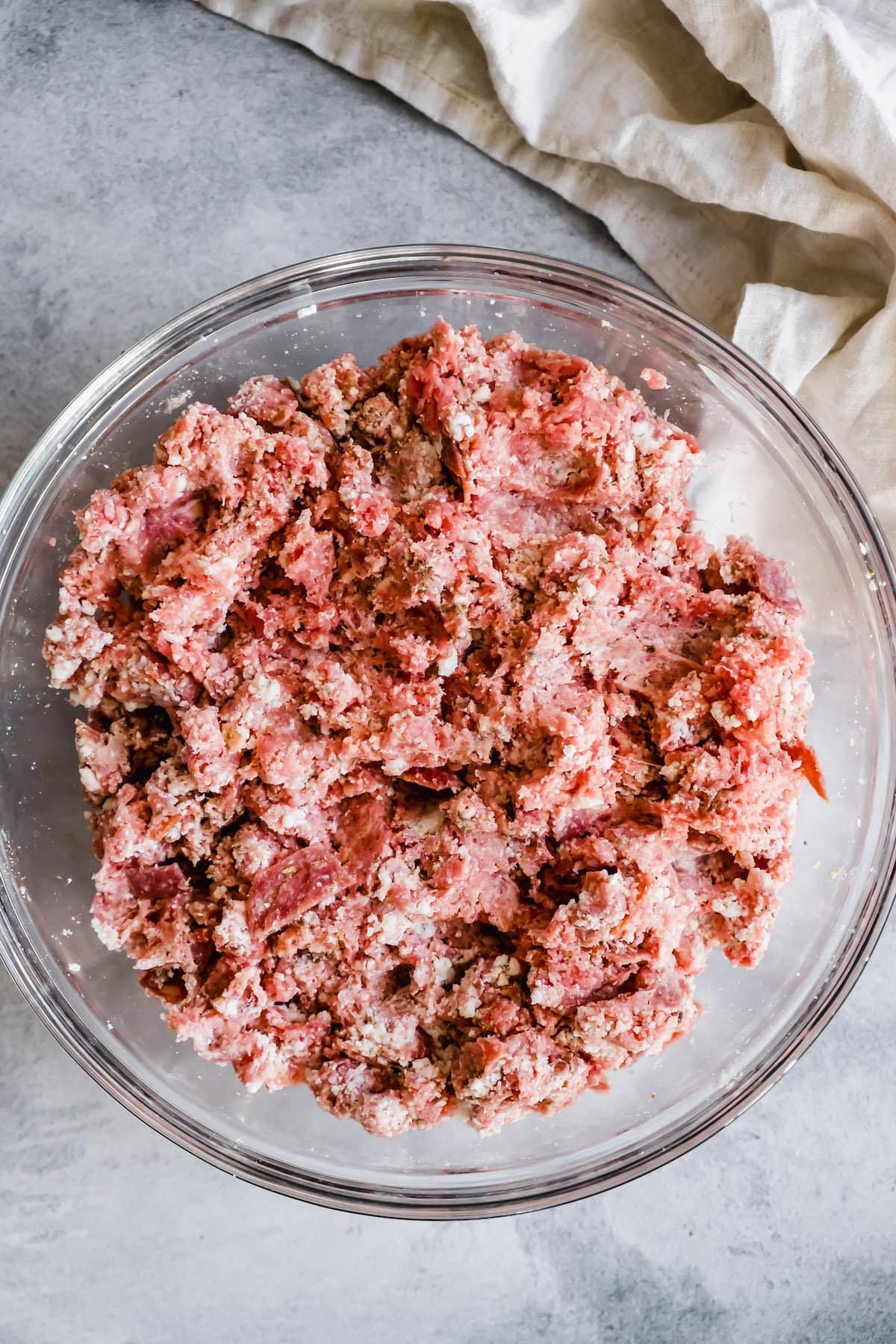 Ground beef for meatloaf mixed with seasonings.