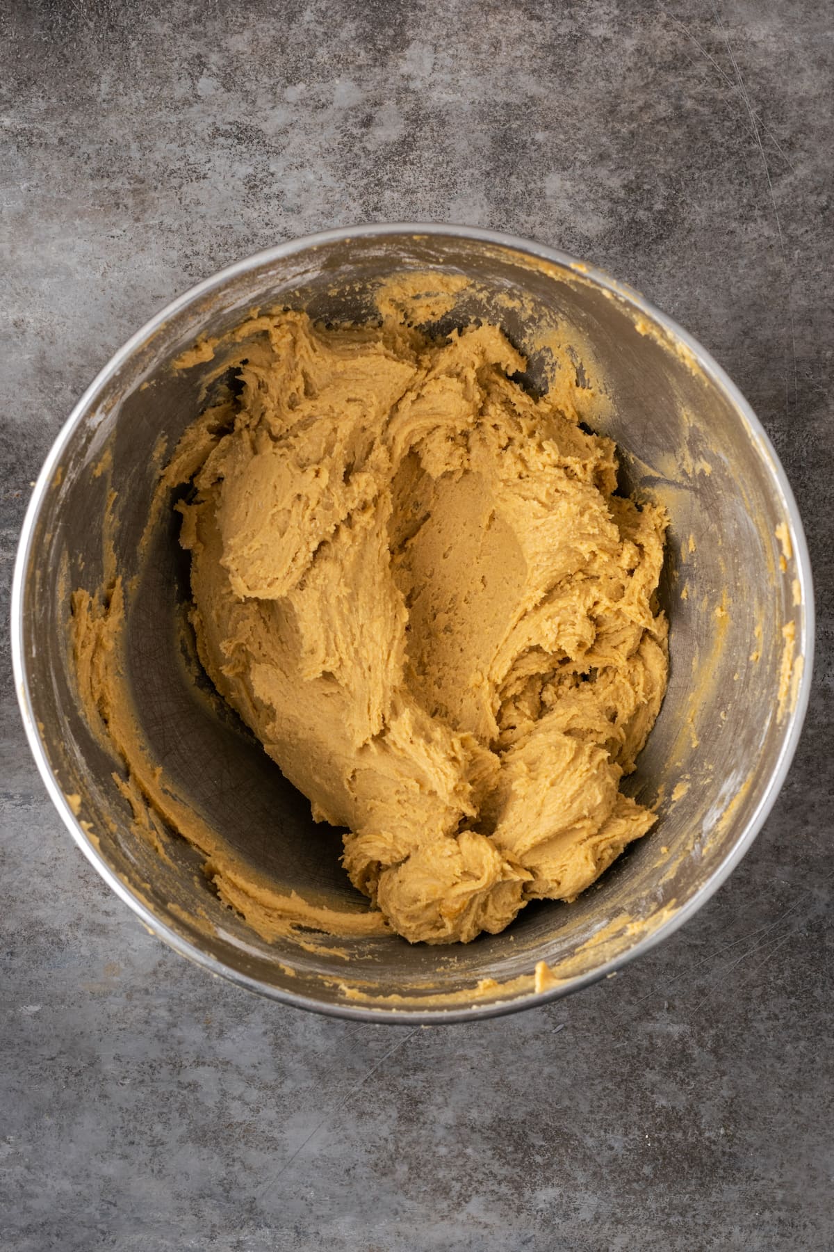 Cake mix cookie dough in a metal mixing bowl.