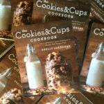 A Pile of Cookies & Cups Cookbooks on a Wooden Table